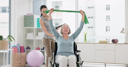 Woman Assists Senior Woman in Exercise with Band