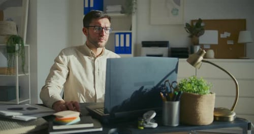 Male Entrepreneur Working on Laptop at Office