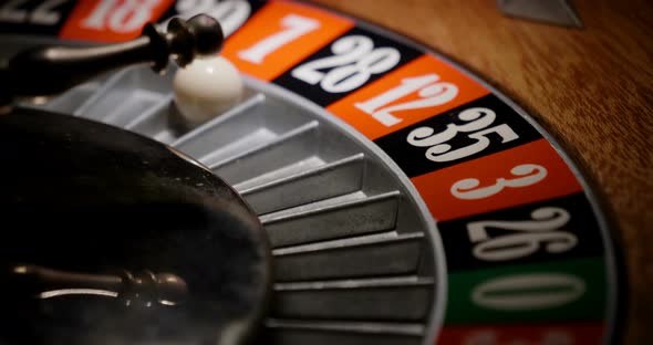 Macro shot of a roulette in a casino where the ball goes to the green ...