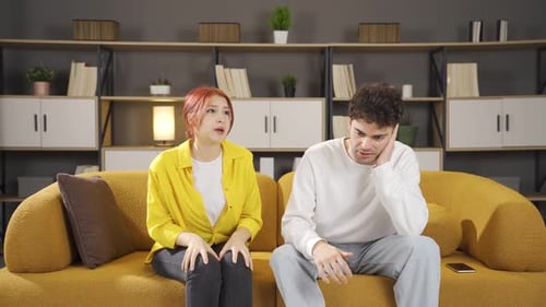Couple Arguing on Couch in Home Setting