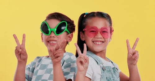 Peace sign, sunglasses and face of children in studio for confidence, funny style