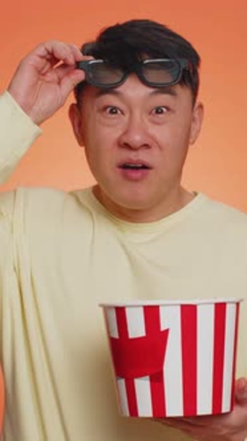 Man with 3D Glasses Eats Popcorn