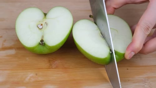 Fresh Green Apple Slicing on Wooden Board