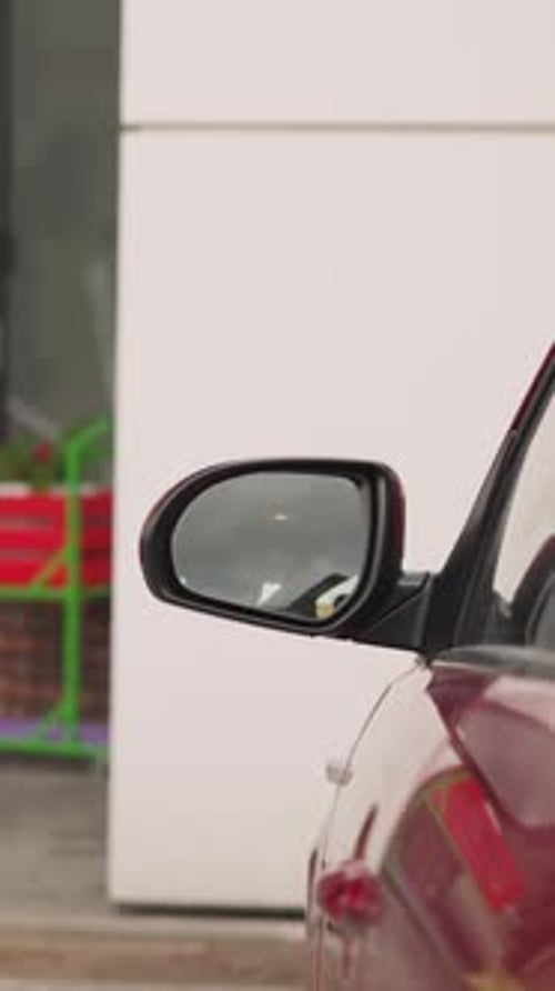 Stylish Woman with Leather Bag on Shoulder Closes Car Door