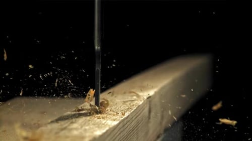 A Carpenter Drills a Hole in a Wooden Product Filmed on a Highspeed Camera at 1000 Fps