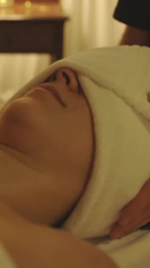 Woman Relaxing with a Towel Wrap at Spa