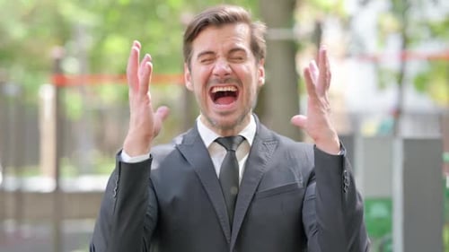 Furious Man Yelling Angrily Outdoors in Frustration