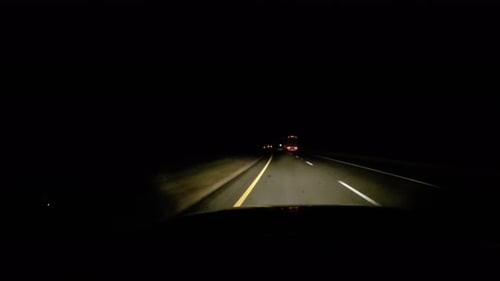 Driving down the Interstate at night.