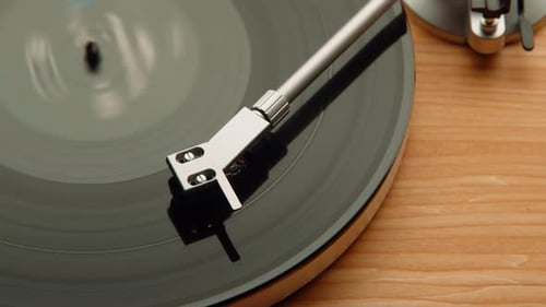 Detailed Close Up of a Vintage Record Player's Needle on a Spinning Vinyl Album