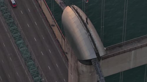 Aerial view of car traffic on a suspension bridge over water