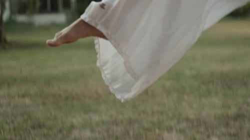 Bare feet walking in a grass field