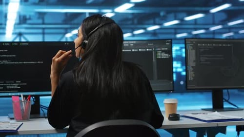 Focused Coder Working at Computer Station