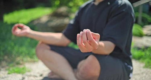 Hands Closeup Young African American Spirituality Man Meditating Yoga Asana Sitting in a Park