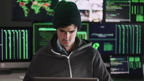 Young Hacker Man Breaking Into Corporate Servers From His Home Office