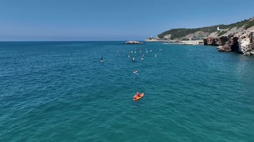 Aerial View Group Paddleboarding in the Bay During a Summer SUP Festival