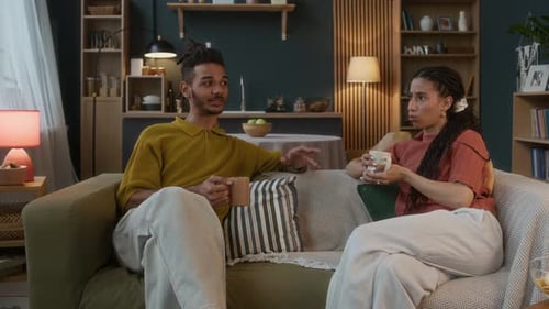 Couple Relaxing and Talking on Couch at Home