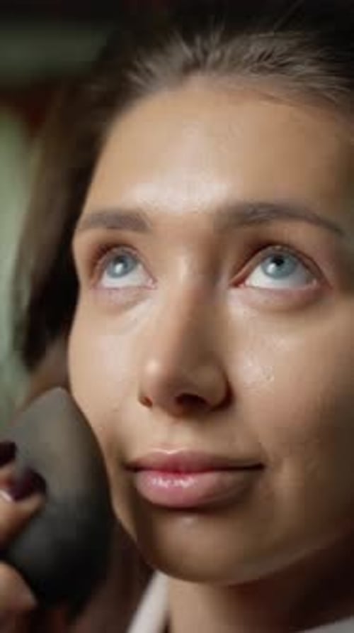 Woman having make-up applied