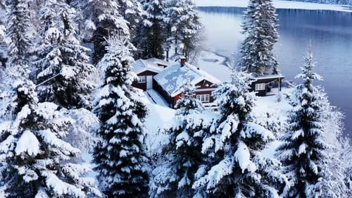 Winter Landscape Of Forest, Cabin, And Frozen Lake In Norway. - aerial ascend
