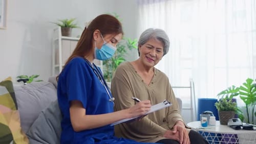 Asian beautiful caregiver examine senior woman patient at nursing home.
