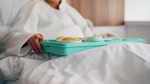 Close-up shot of a tray with healthy food for patient in hospital room in inpatient medical center