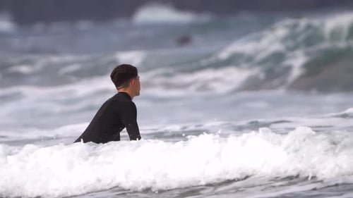 Surfer ride waves in slow motion and walk by the seashore with their surfing table