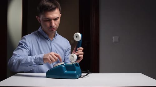 Man Examines Phone Person Studies Teal Telephone Carefully Individual Examines Teal Handset with
