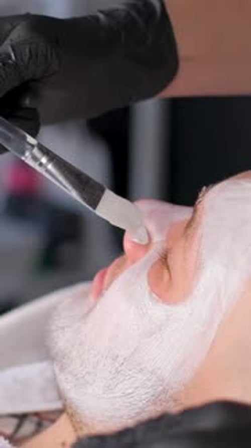 Man Receiving Facial Mask Treatment