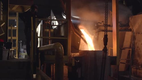Molten Metal Pouring in Dark Industrial Factory