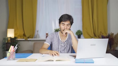 Male student falls asleep while studying.