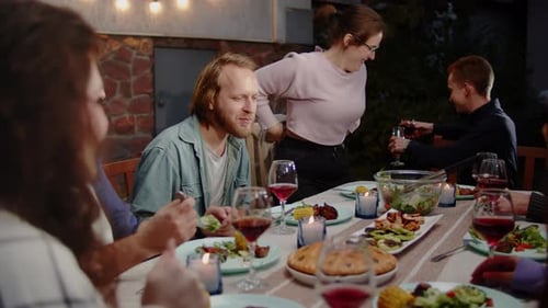 Friends Enjoying Dinner Party Outdoors at Night