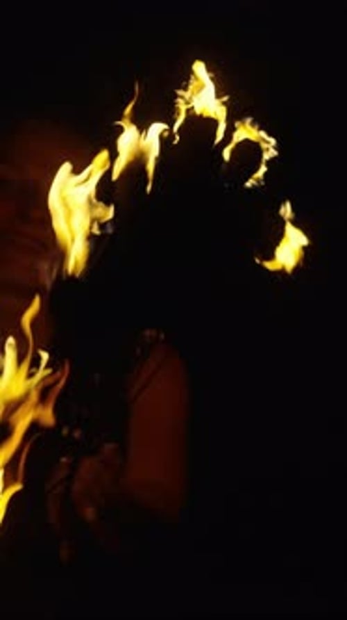Woman Performing with Fire in the Dark