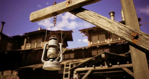 Vintage Metal Lantern Swaying on a Wooden Beam