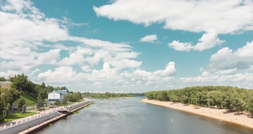 A Breathtaking View of a Serene River Landscape Adorned with a Beautiful Cloudy Sky and Lush