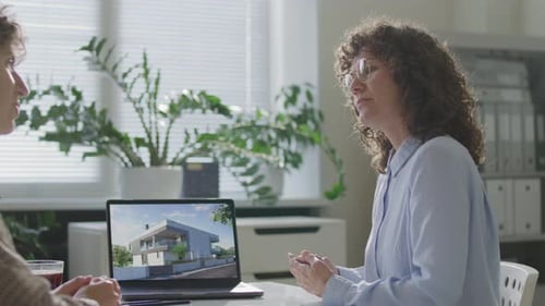 Real Estate Agent Handing over Keys to Client during Property Purchase Meeting