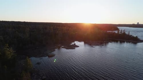 Cinematic Drone View of a Wild Forest and Lake Long Lake with a Beautiful Sunset