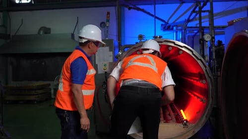 Factory Workers checking Machinery