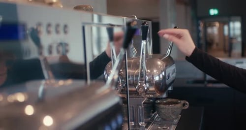 Woman Makes Coffee on Espresso Machine in Cafe