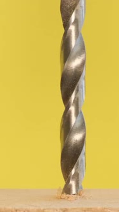 Drill Bit Drilling Into Wood Close Up