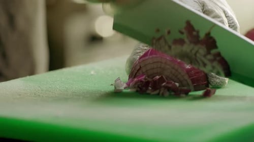 Chef Expertly Cutting Red Onion on Green Cutting Board