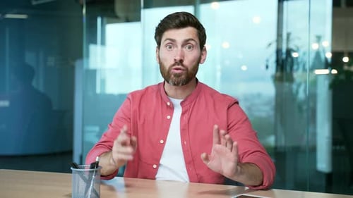 Webcam view of irritated arguing angry mature business man freelancer looking at the camera