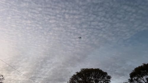 Airplane flying over cloudy sky, Toronto, Canada.
