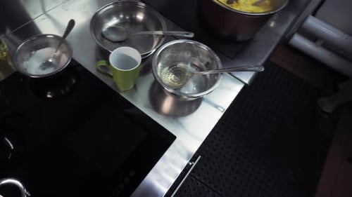 Chef Wearing Gloves Mixing Sauce in Commercial Kitchen
