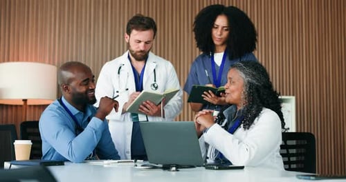 Man, team and doctors at laptop, planning or discussion with workshop in office meeting