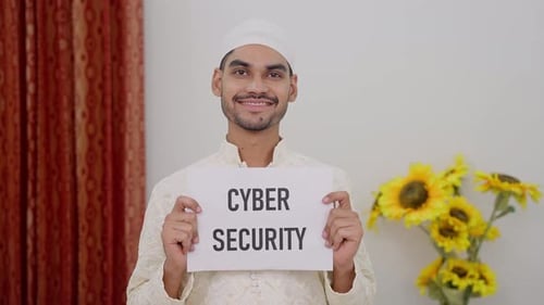 Young Adult Holding Cyber Security Sign Indoors