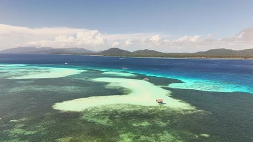Aerial view of Candaraman Sand Bar and turquoise shallows near Balabac, Palawan, Philippines.