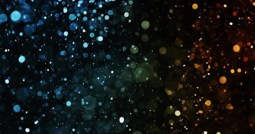 Particules bleues et oranges brillantes tourbillonnant