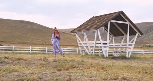 Woman Poses in Rural Field by Gazebo