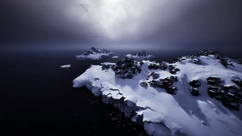 Dramatic Cliffside with Glowing Snow Fields Beneath Darkened Skies