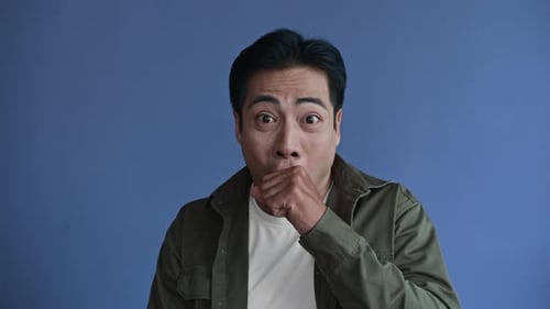 Man Expressing Surprise and Shock Reaction on Blue