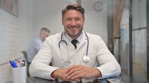 Portrait of Smiling Male Doctor Looking at Camera
